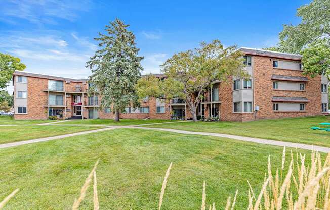 A grassy area in front of apartment buildings.