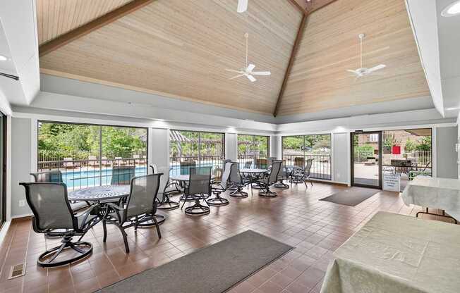 A large room with a pool table and chairs.
