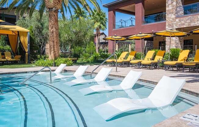 A pool with white chairs and a yellow canopy.