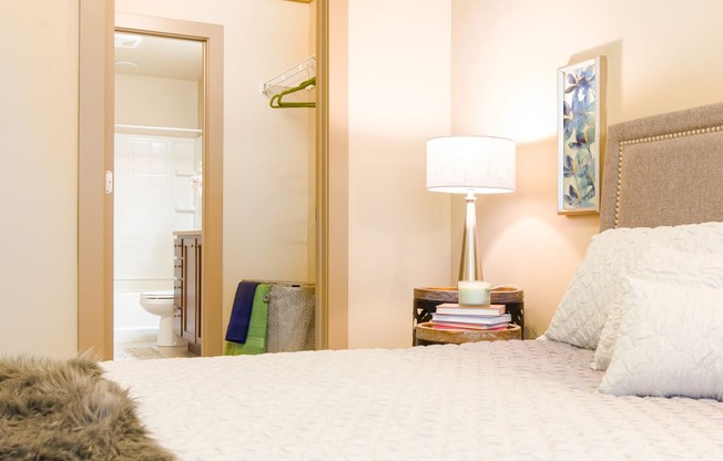 a bedroom with a bed and a mirror and a bathroom at Sugar House Apartments By Urbana, Salt Lake City, UT, 84105