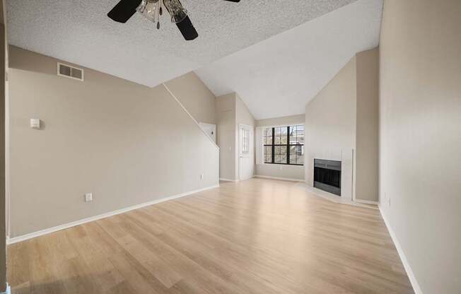 A room with a fireplace and a ceiling fan.
