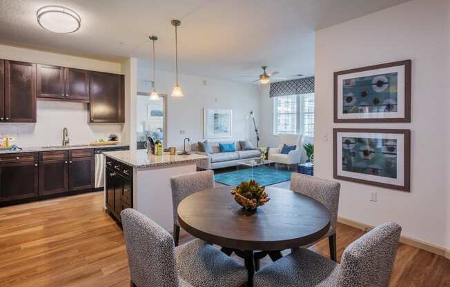 an open living room and kitchen with a dining room table