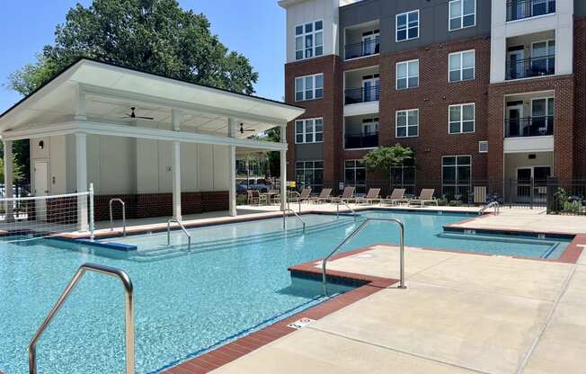 a swimming pool with a building in the background