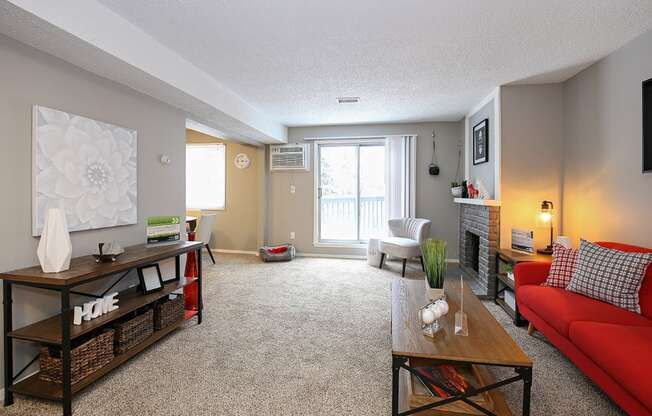 a living room with a red couch and a table