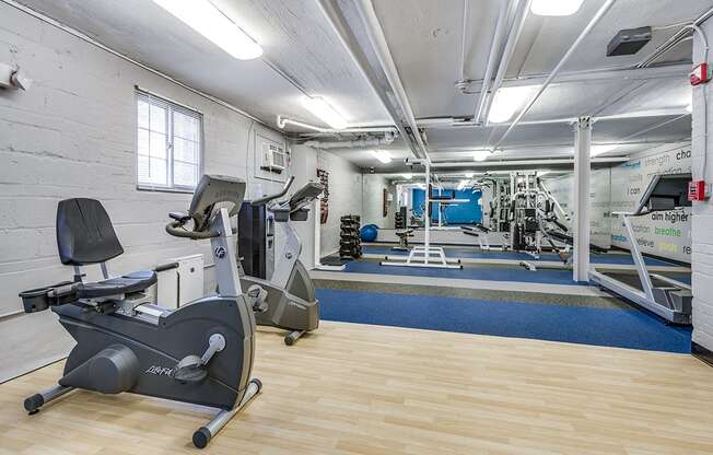 Fitness center with treadmills, machines and free weights at Mason Hall in Alexandria, VA 22314