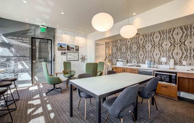 Circa Central open conference room with a long table and chairs and a kitchen in the background