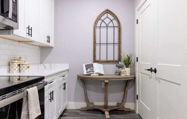 A kitchen with a table and a window.