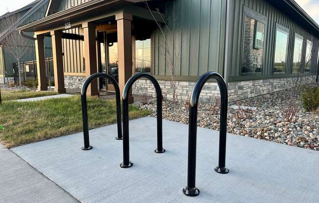 a row of bike racks in front of a building at The Depot, Raymore, MO, 64083