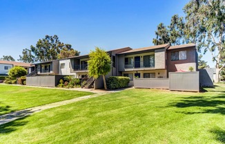 a house with a green lawn in front of it  at Redlands Park Apts, California