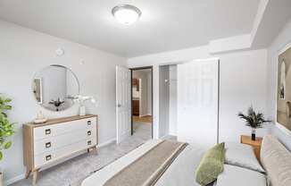 A living room with a dresser, mirror, and couch.