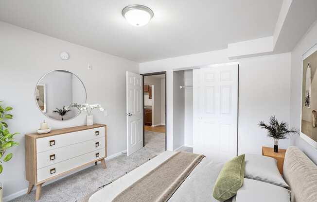 A living room with a dresser, mirror, and couch.