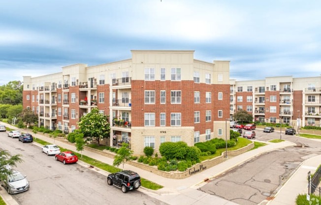 an aerial view of an apartment building with cars parked in front of it