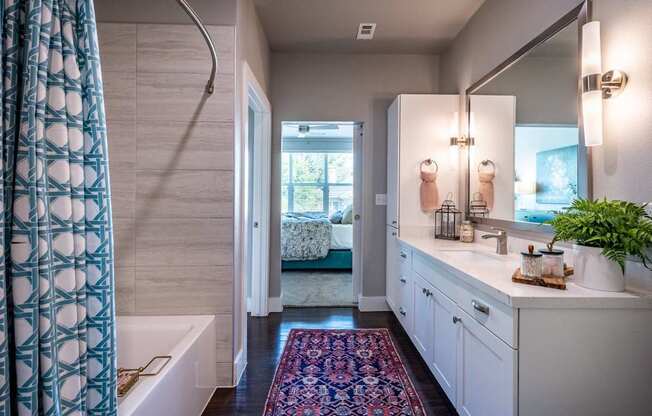 A bathroom with a white tub and a white sink.