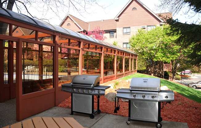 Two silver grills next to shaded terrace
