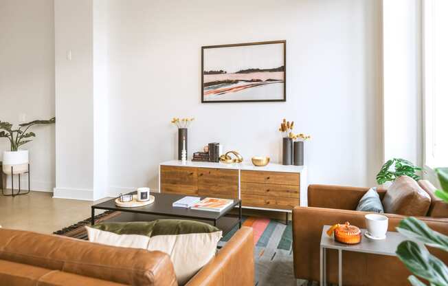 a living room with white walls and brown leather furniture  at The Ferguson, Michigan