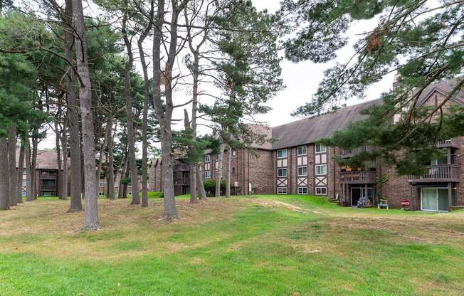 a large brick building with trees in front of it