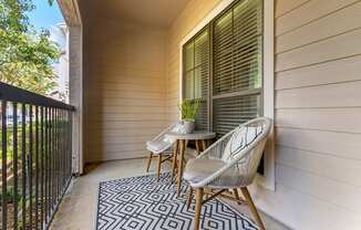 a balcony with a chair and a table on it at Summerwind, Texas