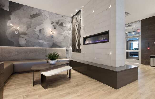 a living room with a couch and a table at Apartments at Denver Place, Denver, CO