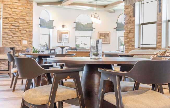 A dining room with a table and chairs.