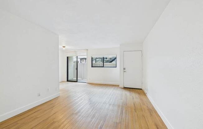 A room with a wooden floor and white walls.