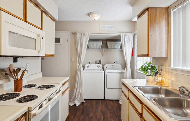 a kitchen with a stove top oven and a sink