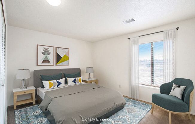 A bedroom with a bed, chair, and a window at Madeira Apartments in Kalamazoo, MI 49001