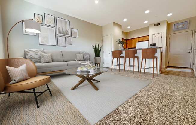 Liberty Bend Apartments, Sandy, Utah, living room with a couch and a table in front of a kitchen