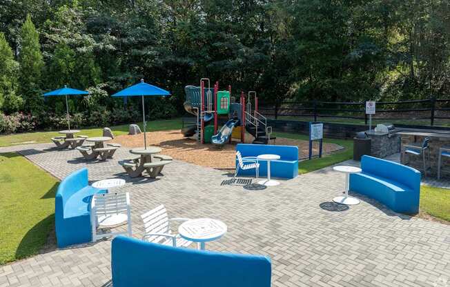 A playground with blue seating and a slide.