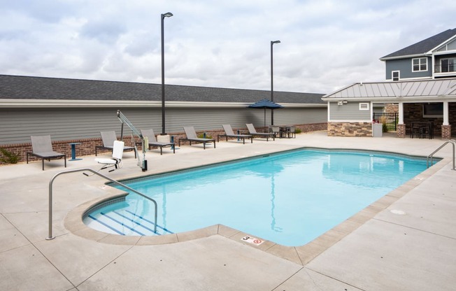 A small pool with a concrete floor and a metal railing.