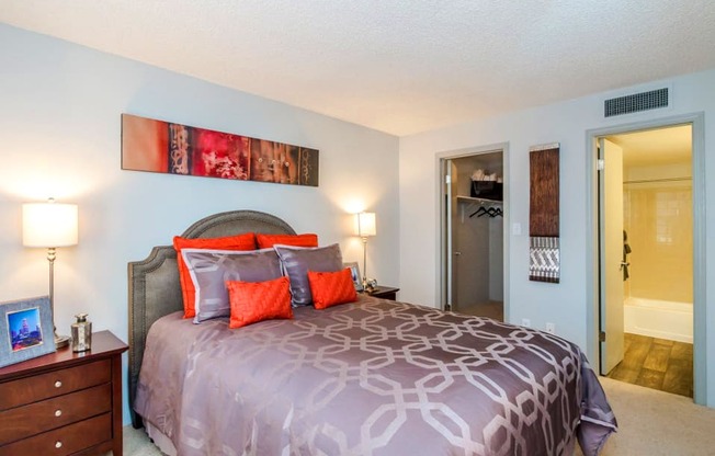 a bedroom with a bed and a door to a bathroom at Skyview Apartments, Colorado