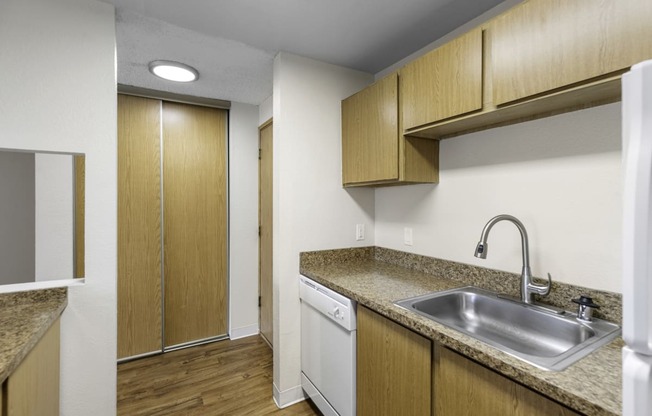 a kitchen with a sink and a dishwasher at Willows Court Apartment Homes, Seattle, Washington 98125