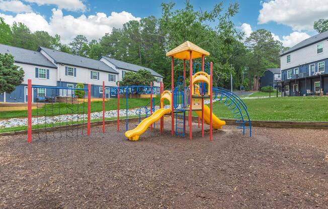 a group of people standing in front of a playground