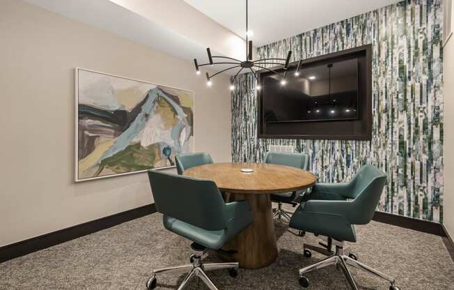 a conference room with a table and chairs and a television