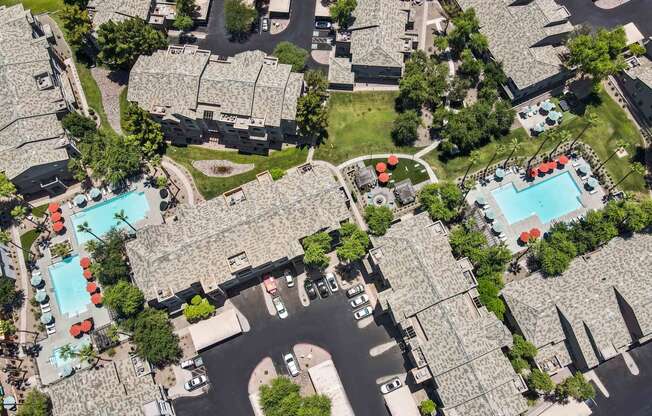 arial view of a neighborhood with lazo apartments and pools