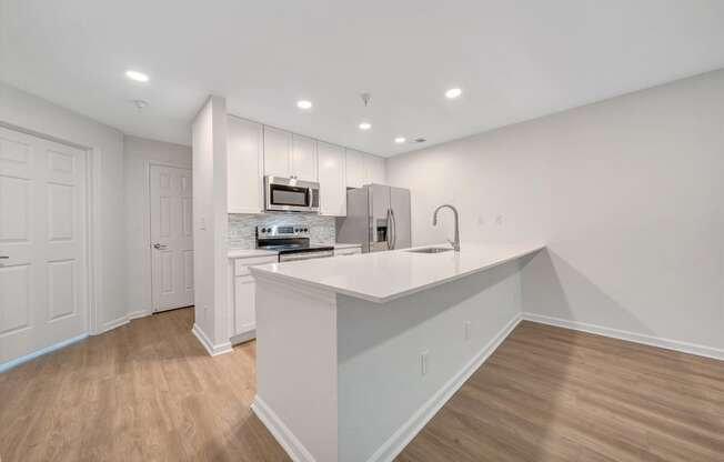 a kitchen with white cabinetry and a white quartz countertop