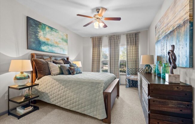 a bedroom with a bed and a ceiling fan