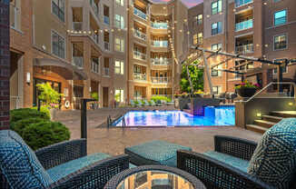 A large building with a pool in the middle of a courtyard.