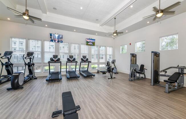 Premium fitness center with cardio equipment, free weights, and weight machines at The Station at Brighton apartments for rent in Grovetown, GA