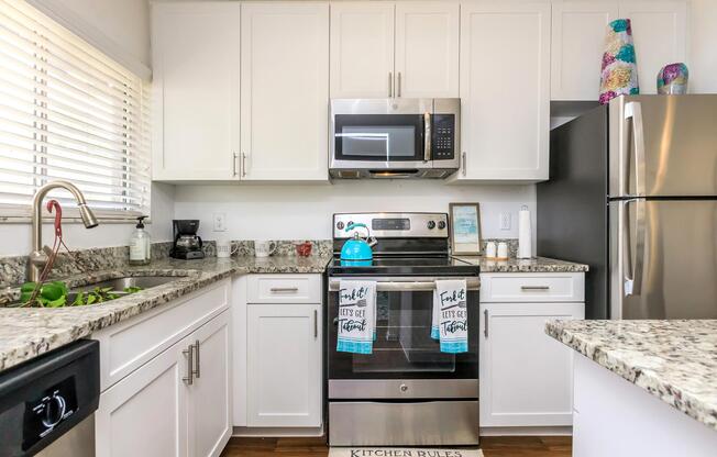 a stove top oven sitting inside of a kitchen