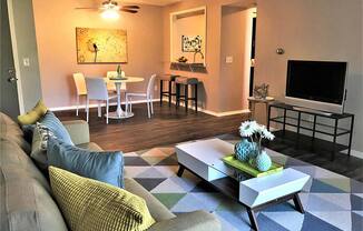 Large modern living room with adjacent dining room at Camelot East Apartments, Ohio, 45014