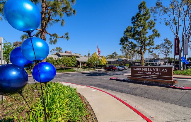 A sign for Park Mesa Villas Apartment Homes is in front of a building.