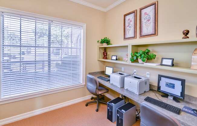 Community business center with computers and chairs.