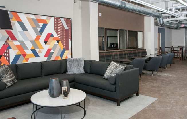 Large Industrial Style Lobby with Various Couches and Colorful Art at 700 Central Apartments in Minneapolis, MN