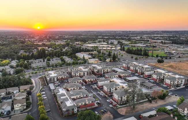 an aerial view of Sierra Gateway Apartments at sunset with Sierra College in the distance