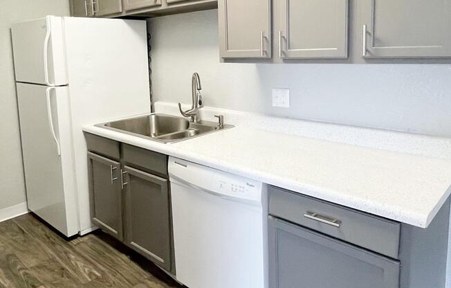 a kitchen with a sink and a refrigerator