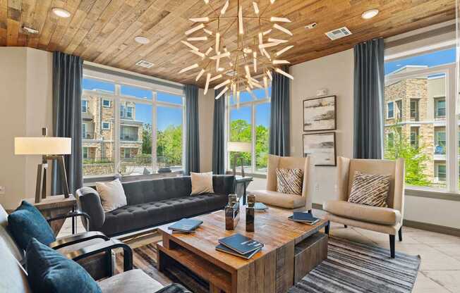 A modern living room with a large window and a view of a building outside.