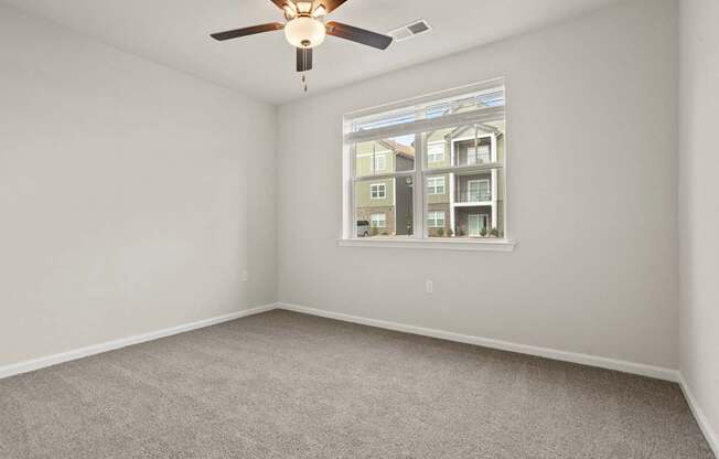 The Grande at Geyser Falls Bedroom with Cream Carpet and Ceiling Fan