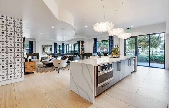 A modern kitchen with a white island and wooden floors.