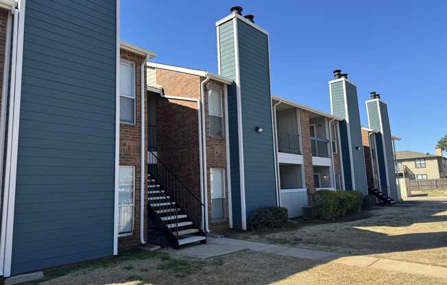 an image of a row of apartment buildings with stairs