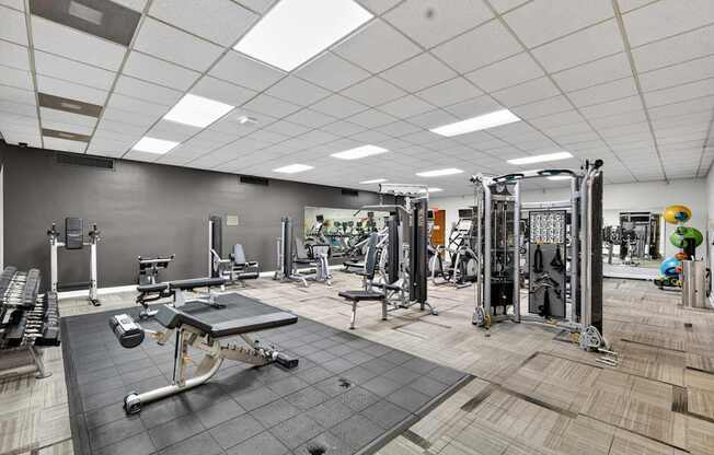 A gym with a variety of equipment including a leg press machine.